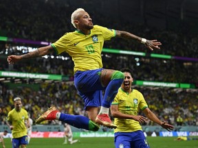 Brazil's Neymar celebrates scoring their first goal with Marquinhos.