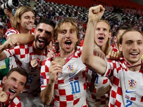 Croatia's Luka Modric and teammates celebrate with their medals as they finish in third place at the Khalifa International Stadium in Doha, Qatar on Dec. 17. 2022.