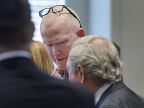 Alex Murdaugh, centre, talks with his defense attorney Dick Harpootlian after a hearing in Colleton County on Monday, Aug. 29, 2022.