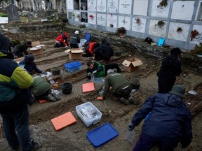 Volunteers and members of Aranzadi Science Society gather the remains of 53 Republican prisoners that died in a Francoist prison in 1941, in the Basque town of Orduna, Spain, December 11, 2022.