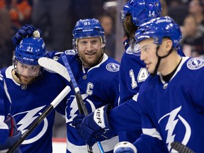 The Tampa Bay Lightning mob Steven Stamkos after he recorded his 1,000th career point against the Philadelphia Flyers at Wells Fargo Center.