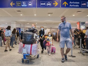 Ukrainian nationals fleeing the ongoing war in Ukraine, left, arrive in Montreal, Sunday, May 29, 2022.