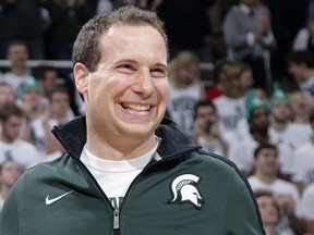 Former Michigan State player Mat Ishbia laughs as he are introduced along with Michigan State's 2000 national championship NCAA college basketball team during halftime of the Michigan State-Florida game in East Lansing, Mich.