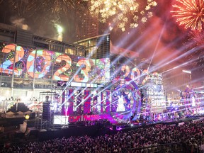 Fireworks explode in the sky over Central World Department Store as thousands of people gather on January 1, 2023 in Bangkok, Thailand.
