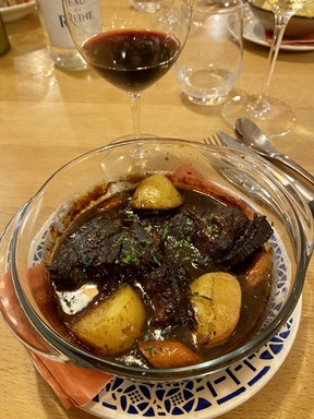 A glass of Gerard Bertrand Cigalus Rouge with a braised beef cheek casserole with Corbieres red wine, carrots, onions and potatoes at Chez Paule restaurant at Château L’Hospitalet. CYNTHIA MCLEOD/TORONTO SUN