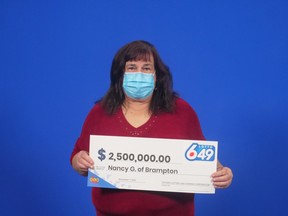 Brampton's Nancy Gardner holds her oversized cheque for $2.5 million.