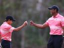 Tiger Woods of the United States and son Charlie Woods celebrate on the seventh green during the first round of the PNC Championship at Ritz-Carlton Golf Club on Dec. 17, 2022 in Orlando, Fla.