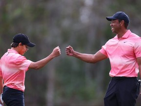 Tiger Woods of the United States and son Charlie Woods celebrate on the seventh green during the first round of the PNC Championship at Ritz-Carlton Golf Club on Dec. 17, 2022 in Orlando, Fla.