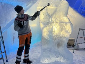 Artist Tjasa Gusfors working on the ice statue of Borje Salming.
