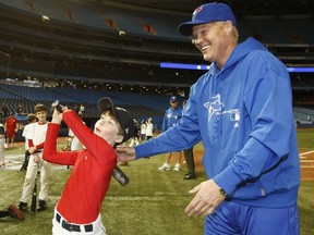 Toronto Blue Jays held the start of their Winter caravan at the Roger's Centre Saturday January, 7, 2012. Former Blue Jay , Pat Tabler, has some fun with Richard Briand (10 yrs old ).