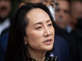 Meng Wanzhou, chief financial officer of Huawei, reads a statement outside B.C. Supreme Court, in Vancouver, Sept. 24, 2021. The U.S. Department of Justice is asking a New York judge to dismiss the remaining indictment against the Chinese tech executive.