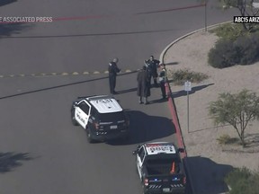 This image made from video provided by KNXV shows law enforcement outside an Amazon delivery hub in the Phoenix suburb of Chandler, Ariz., Wednesday, Dec. 14, 2022.