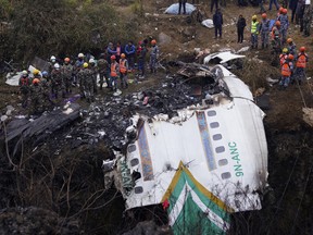 Rescuers scour the crash site in the wreckage of a passenger plane in Pokhara, Nepal, Monday, Jan. 16, 2023.