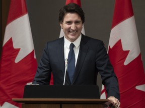 Prime Minister Justin Trudeau smiles as he is welcomed to caucus on Parliament Hill, Friday, Jan. 27, 2023 in Ottawa.