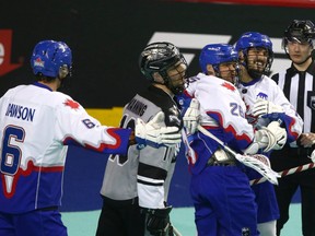 Toronto Rock players celebrate the winning goal in overtime in a National Lacrosse League game against the Calgary Roughnecks in Calgary on Jan. 28, 2023.