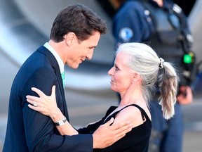 Canadian Prime Minister Justin Trudeau (left) greets Canadian Ambassador to France Isabelle Hudon as he arrives in Biarritz, southwest France, on Aug. 23, 2019, on the eve of the annual G7 Summit.