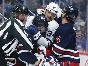The Jets tangle with Maple Leafs star Auston Matthews. (JOHN WOODS/THE CANADIAN PRESS)