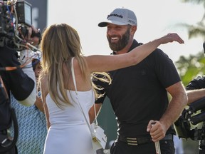 Team Captain Dustin Johnson of 4 Aces GC hugs his wife, Paulina Gretzky, after winning the team championship stroke-play round of the LIV Golf Invitational - Miami at Trump National Doral Miami on October 30, 2022 in Doral, Florida.