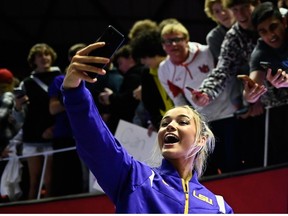 Olivia Dunne of LSU takes a 'selfie' with fans after a PAC-12 meet against Utah at Jon M. Huntsman Center on January 6, 2023 in Salt Lake City, Utah.
