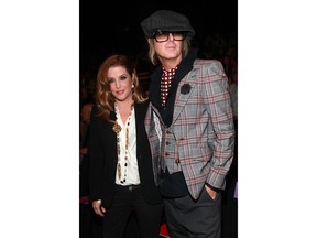 Lisa Marie Presley and Michael Lockwood (R) attend the Anna Sui Spring 2012 fashion show during Mercedes-Benz Fashion Week at The Theater at Lincoln Center on Sept. 14, 2011 in New York City.