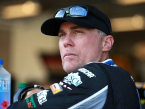 Kevin Harvick, driver of the #4 Unibet Ford, waits in the garage area during qualifying for the NASCAR Xfinity Series Pennzoil 150 at the Brickyard at Indianapolis Motor Speedway on August 14, 2021 in Indianapolis, Indiana.