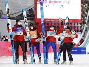Mackenzie Boyd-Clowes, Abigail Strate, Matthew Soukup and Alexandria Loutitt of Team Canada celebrate their bronze medal during Mixed Team Ski Jumping Final Round at National Ski Jumping Centre last year.