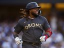 Vladimir Guerrero Jr. of the Toronto Blue Jays smiles as he runs to first base during the 92nd MLB All-Star Game presented by Mastercard at Dodger Stadium on July 19, 2022 in Los Angeles, California.