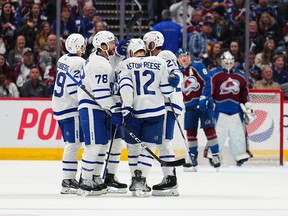 TJ Brodie of the Maple Leafs celebrates a goal against Alexandar Georgiev of the Colorado Avalanche with teammates during the second period at Ball Arena on Dec. 31 in Denver.