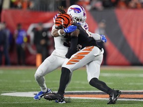 Damar Hamlin #3 of the Buffalo Bills tackles Tee Higgins #85 of the Cincinnati Bengals during the first quarter at Paycor Stadium on January 02, 2023 in Cincinnati, Ohio. Hamlin was taken off the field by medical personnel following the play. (Photo by Dylan Buell/Getty Images)
