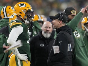 Head coach Matt LaFleur of the Green Bay Packers talks with Quay Walker after he was disqualified for an unsportsmanlike penalty during the fourth quarter against the Detroit Lions at Lambeau Field on January 08, 2023 in Green Bay, Wisconsin.