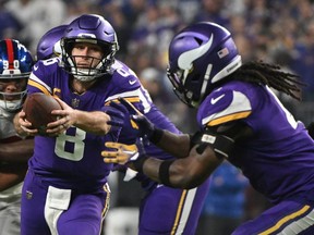 Kirk Cousins of the Minnesota Vikings hands off to Dalvin Cook during the second half against the New York Giants in the NFC Wild Card playoff game at U.S. Bank Stadium on January 15, 2023 in Minneapolis, Minnesota.