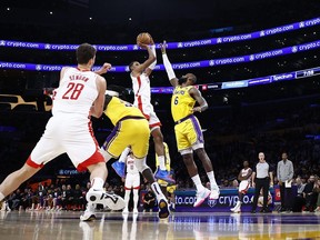 Jabari Smith Jr. #1 of the Houston Rockets takes a shot against LeBron James #6 of the Los Angeles Lakers.