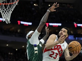 Fred VanVleet #23 of the Toronto Raptors is defended by Bobby Portis #9 of the Milwaukee Bucks during the second half of a game at Fiserv Forum on January 17, 2023 in Milwaukee, Wisconsin.