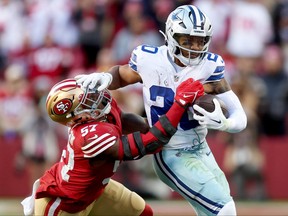 Tony Pollard of the Dallas Cowboys carries the ball against Dre Greenlaw of the San Francisco 49ers during the second quarter in the NFC Divisional Playoff game at Levi's Stadium on Jan. 22, 2023 in Santa Clara, Calif.