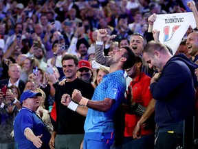 Novak Djokovic of Serbia celebrates in his team's box after winning the Men's Singles Final match against Stefanos Tsitsipas of Greece during day 14 of the 2023 Australian Open at Melbourne Park on January 29, 2023 in Melbourne, Australia.