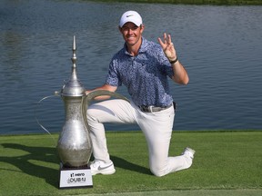 Rory McIlroy of Northern Ireland poses with the Hero Dubai Desert Classic trophy on the 18th green, following victory in the Final Round on Day Five of the Hero Dubai Desert Classic at Emirates Golf Club on January 30, 2023 in Dubai, United Arab Emirates.