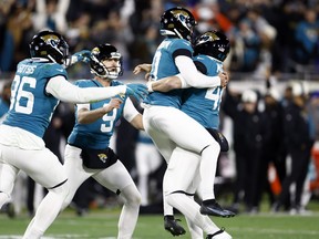 Riley Patterson #10 of the Jacksonville Jaguars celebrates with teammates after kicking a field goal to defeat the Los Angeles Chargers 31-30 in the AFC Wild Card playoff game.