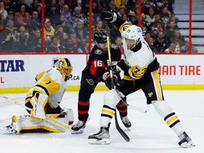 Ottawa Senators left wing Austin Watson and Pittsburgh Penguins defenseman Pierre-Olivier Joseph battle in front of Pittsburgh Penguins goaltender Casey DeSmith during third period NHL action at the Canadian Tire Centre on Wednesday, Jan. 18, 2023.
