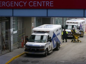 Paramedics push a gurney towards an ambulance outside a Toronto hospital on January 5, 2022.