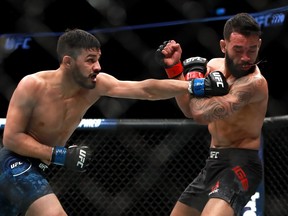 Julio Arce lands a punch against Dan Ige in their Featherweight fight during UFC 220 at TD Garden on January 20, 2018 in Boston, Massachusetts.  (Photo by Mike Lawrie/Getty Images)