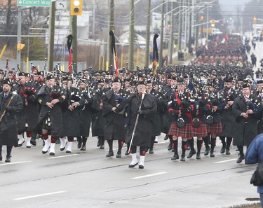 A large contingent of officers from across the province, Canada and U.S. are led down Bayview Ave., in Barrie, with various police Drums  & Pipes band leading the funeral procession for slain OPP Const. Grzegorz Pierzchala. The funeral took place at the Sadlon Arena on Bayview Dr.  on Wednesday January 4, 2023. Jack Boland/Toronto Sun/Postmedia Network
