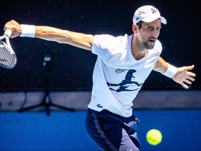 World Number 5 ranked player Novak Djokovic attends a practice match with Russian player Daniil Medvedev ahead of the Australian Open tennis tournament in Melbourne Park on January 11, 2023. (Patrick HAMILTON / AFP)