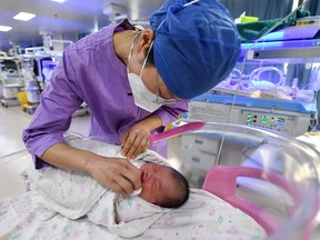 A nurse takes care of a newborn baby at a hospital in Fuyang, in China's eastern Anhui province on January 17, 2023.