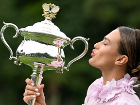 Belarus' Aryna Sabalenka poses with the 2023 Australian Open winner's trophy in Royal Botanic Garden in Melbourne on January 29, 2023, following her victory over Kazakhstan's Elena Rybakina in the women's singles final of the tennis tournament.