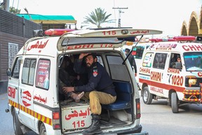 An ambulance transports injured blast victims outside the police headquarters in Peshawar on Jan. 30, 2023.
