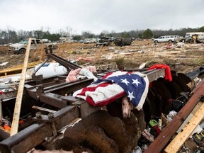 A flag is draped on the remnants of a home destroyed by a tornado on County Road 140 in Old Kingston, Alabama, Friday, Jan. 13, 2023.