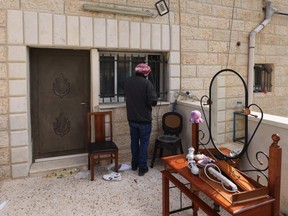 The uncle of Khayri Alqam, the gunman who killed seven people in an attack on Jan. 27, inspects the barricade put up by Israeli soldiers at the Alqam family home in the mostly Arab east Jerusalem neighbourhood of al-Tur, Sunday, Jan. 29, 2023.
