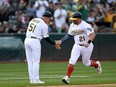 Stephen Vogt, right, of the Athletics runs around the bases after hitting a home run against the Blue Jays at RingCentral Coliseum in Oakland, July 4, 2022.