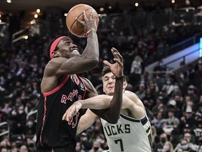 Toronto Raptors forward Pascal Siakam  is fouled by Milwaukee Bucks guard Grayson Allen  in the fourth quarter at Fiserv Forum.