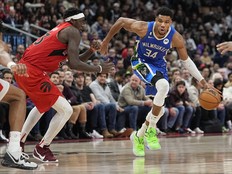Milwaukee Bucks forward Giannis Antetokounmpo (34) drives to the net against Toronto Raptors forward Pascal Siakam (43) during the second half at Scotiabank Arena.